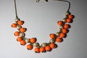 lot 189 image: Orange and pearl ball bead necklace with oversize spring ring clasp. 18L. Has J Crew hang tag.