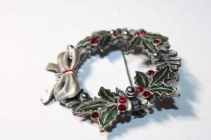 lot 204 image: Signed Kenneth Cole enamel holiday wreath broochpin. Marked KC on reverse. 2W