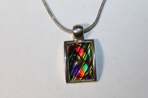 lot 205 image: Signed Kenneth Cole faceted mosaic glass pendant necklace. Marked Kc on reverse. 14L with 3 extender. Pendant 1.5L