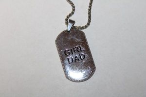 lot 211 image: JEWELRY - Signed LA CN lateral antebrachial cutaneous neuropathy pain relief magnet stainless steel jewelry necklace with Girl Dad dog tag on 20L popcorn chain necklace.