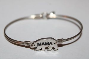 lot 219 image: Signed Luca  Danni silver wire signature oval shape Mama Bear bracelet. Has L  D hang tag. Hook and catch closure.