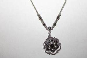 lot 220 image: Signed Liz Claiborne marcasite and faceted black crystal pendant necklace. Marked Liz Claiborne Est 1976 LC on hang tag. 18L