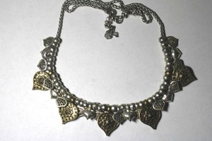 lot 228 image: Signed Lucky brand two-tone ball bead and rope chain necklace with Eastern Moroccan-inspired dangles. Has 4-leaf clover hang tag. 18L