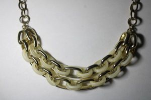 lot 238 image: Signed Banana Republic gold tone and acrylic interlinked necklace. Has BR hang tag. Lobster clasp. 16L