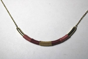 lot 244 image: Signed Anne Taylor Loft gold tone half moon necklace with pink and red wrapped smile pendant. Has Loft hang tag. Lobster clasp. 14L