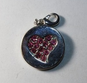 lot 257 image: Signed Mary Kay charm with lobster clasp. Marked Mary Kay in script on one side and pink crystal heart on reverse.