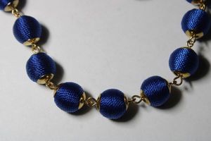 lot 259 image: Signed Natasha silk wrapped blue ball station necklace with gold plated necklace. Has Natasha hang tag. Lobster clasp. 20L with 3 extender
