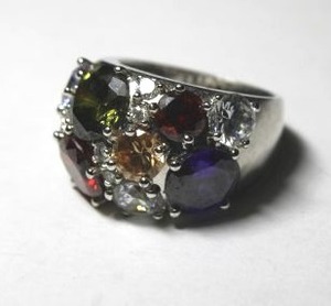 lot 263 image: Signed NVC (Nataliya V Collister) rhodium plated multi color CZ rainbow prong set cluster ring. Size 9. Comfort fit inside. Marked NVC inside.