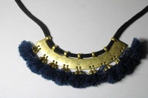 lot 269 image: Signed Madewell bohemian navy tassel gold tone corded choker. Marked M. Oversize spring ring clasp. 14L