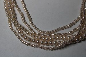lot 272 image: Signed Marvella 5-strand faux pink seed pearl necklace. Has Marvella hang tag. Pearl push clasp. 26L