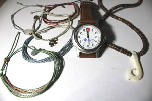 lot 276 image: Signed Pura Vida bracelets with hang tags. Includes a Sun brand watch with leather band and 16 wood bead choker with bone carved fish hook pendant.