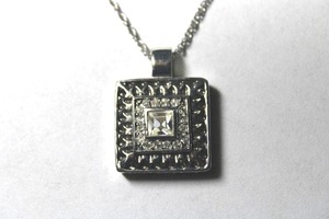 lot 287 image: Signed Roman CZ pendant on 18L necklace. Marked Roman on back of pendant.