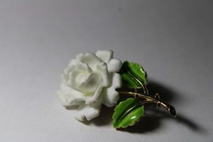 lot 304 image: Signed Crown Trifari (mark used 1955-1969) enamel flower broochpin. 2L. Marked Trifari with crown on reverse.