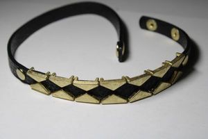 lot 310 image: Signed Yic Fung leather geometric studded choker with snap closure. Marked Yic Fung on snap.Adjustable14-15L