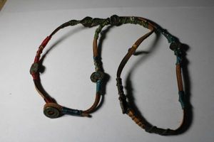 lot 313 image: Signed Wakami Global bohemian silk wrapped leather necklace with bronze color button stations and button closure. Artisan crafted equality purpose jewelry. Has Wakami button. 27L