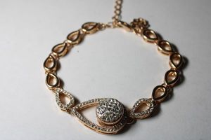 lot 315 image: Signed Magnolia rose gold plated bracelet with faceted glass pear shape stations. Has M hang tag. Lobster clasp. 18L