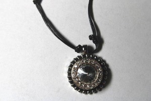 lot 316 image: Signed Magnolia faceted CZ pendant on a silver ball bead station corded necklace. Has M hang tag. 32L