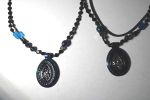 lot 328 image: (2) Signed Chicos enamel pendant necklaces with black flat disc and glass beads. Both about 18L with Chicos hang tags.