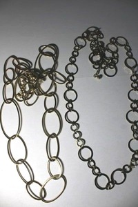 lot 331 image: (2) Signed Chicos flat disc modernist necklaces. Oval link 34 with 3 extender, Round link 32L with 3 extender. Both with hang tags.