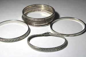 lot 98 image: (10) Signed Monet silver tone bracelets - (9) bangles and (1) flex bracelet. Marked Monet.
