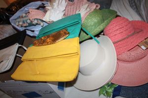 lot 172 image: Sun hats, womens clutch purses, gloves, crocheted baby sweater and decorative pillows