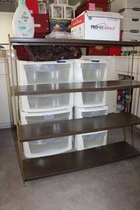 lot 199 image: metal bookshelf, white stackable storage drawers, Nebulizer, and travel bags