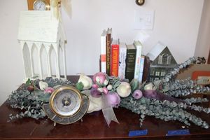lot 9 image: Home Dcor wooden church, floral swag, books, Desk barometer, and metal house