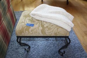 lot 20 image: Foot stool with iron base plus throw blanket