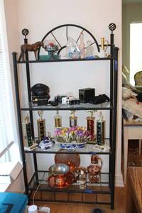 lot 31 image: Black metal shelf with glass shelves. Approx. 36x15x6 (not contents)