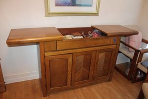 lot 40 image: Oak Buffet cabinet, top splits and extends. Measures Approx. 47x18x35 Contents sold separately.