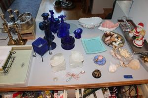 lot 48 image: Blue glass collection, Brass and other candle holders, shells, and more