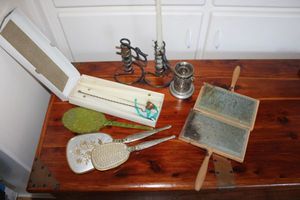 lot 7 image: Vintage vanity set brush and mirror, courting candle holders, sheep combs stamped Clemes & Clemes Pinole Calif., tapers, and candle snuffer.