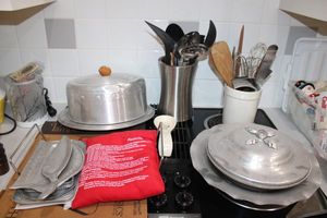 lot 61 image: Aluminum trays and cake plate, cooking utensils, Microwave potato bag