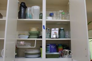 lot 71 image: Vintage green dishes, Ball jar, Wine bottle stoppers, water pitchers and more