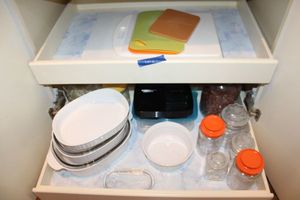 lot 81 image: French white baking dishes, candy jars, and cutting boards