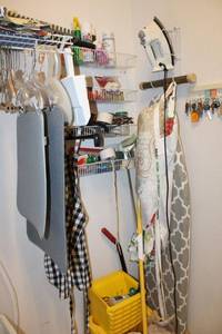 lot 82 image: Mop bucket and mops, ironing board, iron, tape guns and Misc.