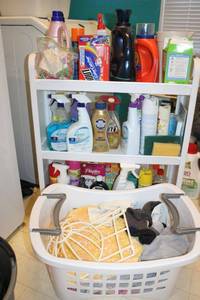 lot 88 image: Narrow rolling shelf with cleaners (fits between washer and dryer) plus laundry basket