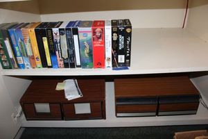 lot 104 image: VHS movies and VHS movie storage drawers