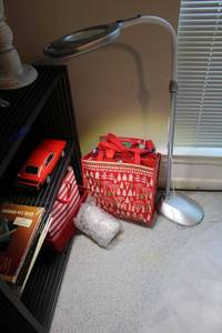 lot 263 image: Floor lamp with magnifier, gift bags, Hallmark Gift mug, red model car and computer books