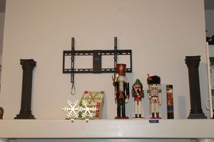 lot 108 image: Pair and pillar candle holders, The Grinch snow globe, decorative nutcrackers, and Christmas stocking hangers