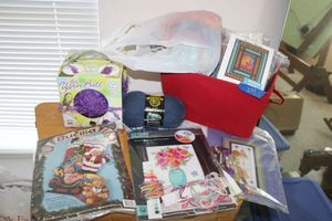 lot 239 image: Sewingcraft kits, embroidery floss, yarn ball, and fabric