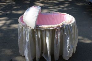 lot 291 image: Vintage baby bassinet and baby clothes and blankets