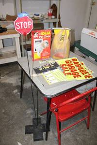 lot 296 image: Card table, folding red chair, garage sale signs, pet door, cat litter, and garage stop sign car stopper