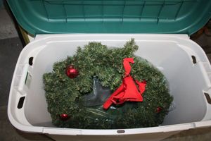 lot 298 image: 50 Gal. Sterlite tote with 2 Christmas wreathes