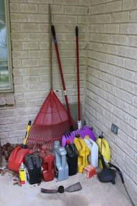 lot 331 image: Automotive oils, drain snake, plastic rack and leaf scoops, metal plow (needs handle)