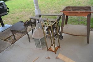 lot 257 image: Misc. outdoor items grill stand, lantern, vintage sewing machine stand and more
