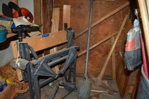 lot 215 image: Folding work table, shovel, post hole digger, and axes