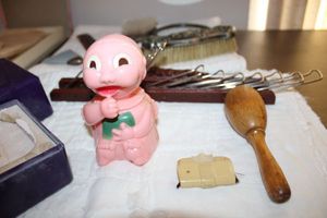 lot 133 image: Vintage plastic toy baby with sucker, vanity brush and mirror sets, tie rack, powder box