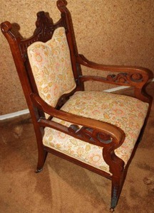 lot 143 image: Vintage upholstered armchair with wooden wheels