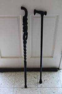 lot 7 image: Black walking canes (one is wood carved with broken handle)
